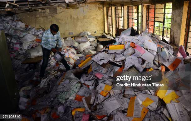 An RTO personnel inspects the papers which were damaged due to fire broke out on the first floor of the Regional Transport Office due to short...