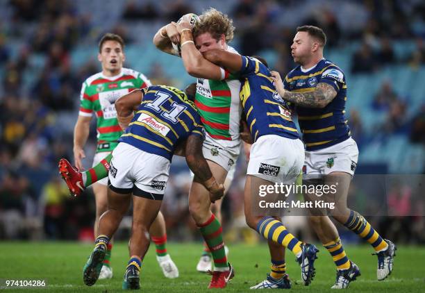 George Burgess of the Rabbitohs is tackled during the round 15 NRL match between the Parramatta Eels and the South Sydney Rabbitohs at ANZ Stadium on...