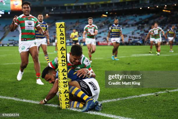 Josh Hoffman of the Eels is tackled over the sideline by Dane Gagai of the Rabbitohs during the round 15 NRL match between the Parramatta Eels and...