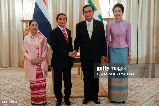 Myanmar's First Lady Cho Cho stands besides Myanmar's President Win Myint as he shakes hands with Thailand's Prime Minister Prayut Chan-o-cha , next...