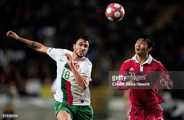 Hugo Almeida of Portugal challenges Wang Qianq of China during the International Friendly match between Portugal and Republic of China at the City of...