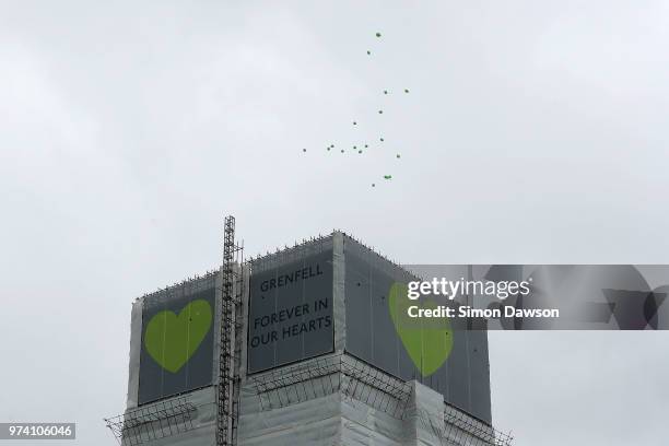 Green balloons are released over Grenfell Tower on the one year anniversary of the Grenfell Tower fire on June 14, 2018 in London, England. In one of...