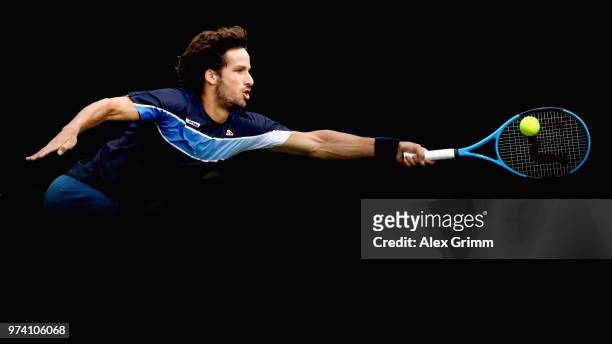 Feliciano Lopez of Spain plays a forehand to Gilles Simon of France during day 4 of the Mercedes Cup at Tennisclub Weissenhof on June 14, 2018 in...