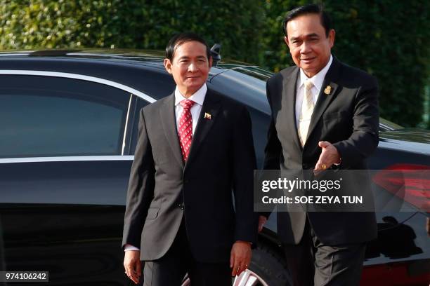 Thailand's Prime Minister Prayuth Chan-ocha welcomes Myanmar's President Win Myint at the Government House in Bangkok on June 14, 2018.