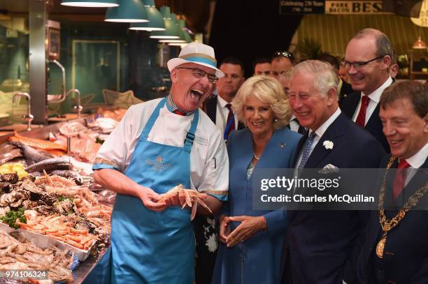 Prince Charles, Prince of Wales and Camilla, Duchess of Cornwall meet fishmonger Pat O'Connell as they visit the English Market on June 14, 2018 in...