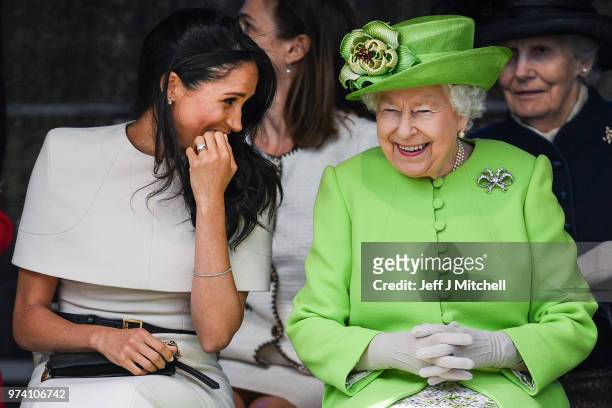 Queen Elizabeth II sitts and laughs with Meghan, Duchess of Sussex during a ceremony to open the new Mersey Gateway Bridge on June 14, 2018 in the...