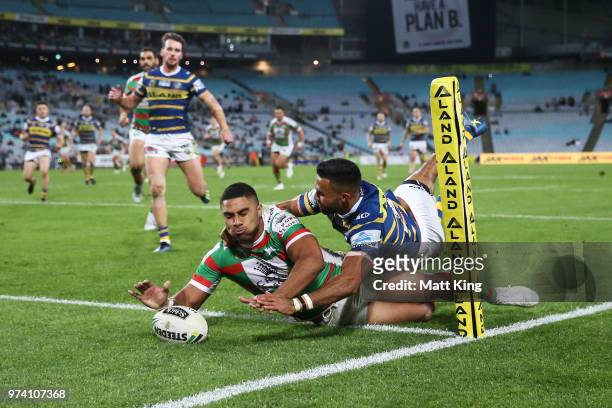 Robert Jennings of the Rabbitohs beats Bevan French of the Eels to score in the corner during the round 15 NRL match between the Parramatta Eels and...