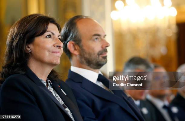 Paris city mayor Anne Hidalgo and French Prime Minister Edouard Philippe listen to the speech of the International Olympic Committee member and...