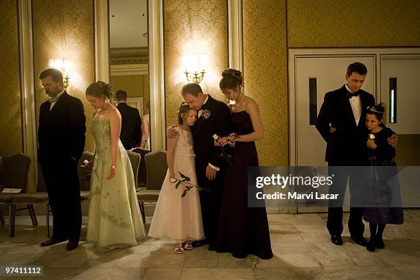 Fathers and daughters pray together in the ballroom of the Broadmoor Hotel on May 16, 2008 in Colorado Springs, Colorado. The annual Father-Daughter...