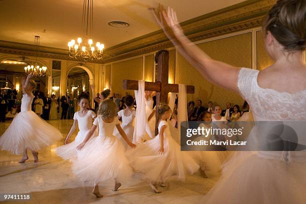 The Regal Daughters Ballet Company dance around the wooden cross in the ballroom of the Broadmoor Hotel on May 16, 2008 in Colorado Springs,...