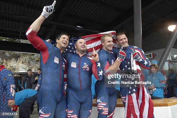 Winter Olympics: USA Team 1 Steve Mesler, Steven Holcomb, Curtis Tomasevicz, and Justin Olsen victorious after winning Men's Bobsled Four Man Final...