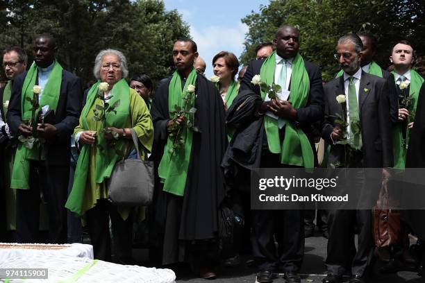 Labour Party MP for Tottenham, David Lammy holds a white rose as he pays tribute outside St Helen's Church to mark the one year anniversary of the...