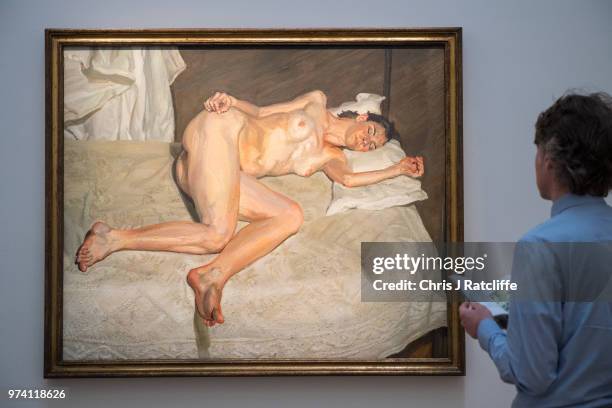 Art handlers adjust 'Portrait on a white cover' by Lucian Freud during a preview of the Contemporary Art sale at Sotheby's on June 14, 2018 in...