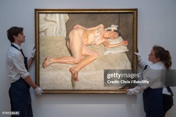 Art handlers adjust 'Portrait on a white cover' by Lucian Freud during a preview of the Contemporary Art sale at Sotheby's on June 14, 2018 in...