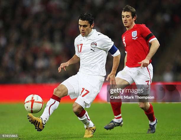 Ahmed Hassan of Egypt is watched by Leighton Baines of England during the International Friendly match between England and Egypt at Wembley Stadium...