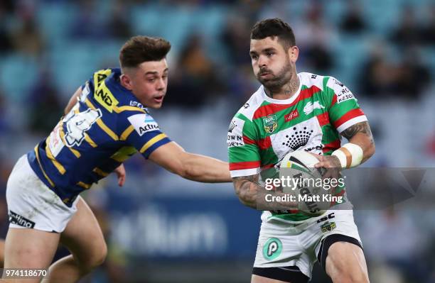 Adam Reynolds of the Rabbitohs gets past Reed Mahoney of the Eels during the round 15 NRL match between the Parramatta Eels and the South Sydney...