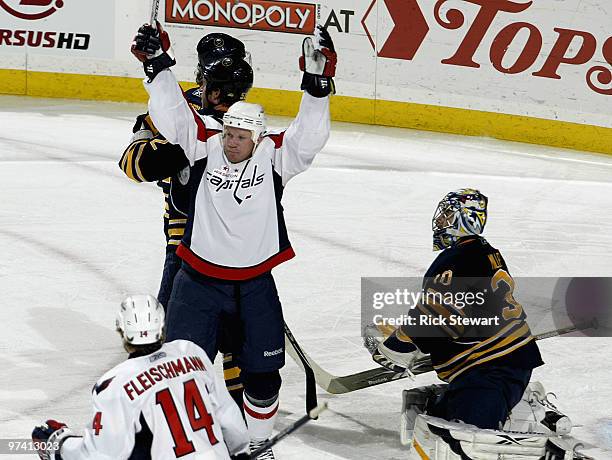 Jason Chimera of the Washington Capitals celebrates a goal by Tomas Fleishmann as Ryan Miller of the Buffalo Sabres looks on at HSBC Arena on March...