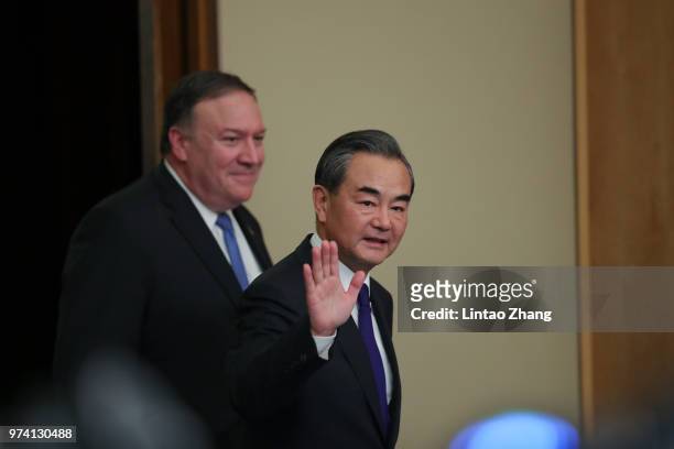 Chinese Foreign Minister Wang Yi with U.S. Secretary of State Mike Pompeo attend a press conference at the Great Hall of the People on June 14, 2018...