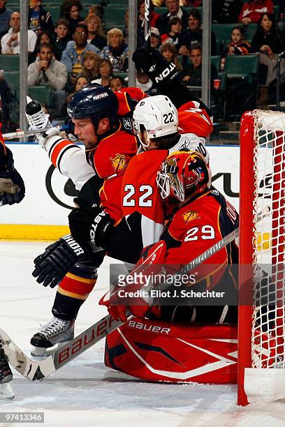 Goaltender Tomas Vokoun of the Florida Panthers and teammate Bryan McCabe defend the net against Ville Leino of the Philadelphia Flyers at the...