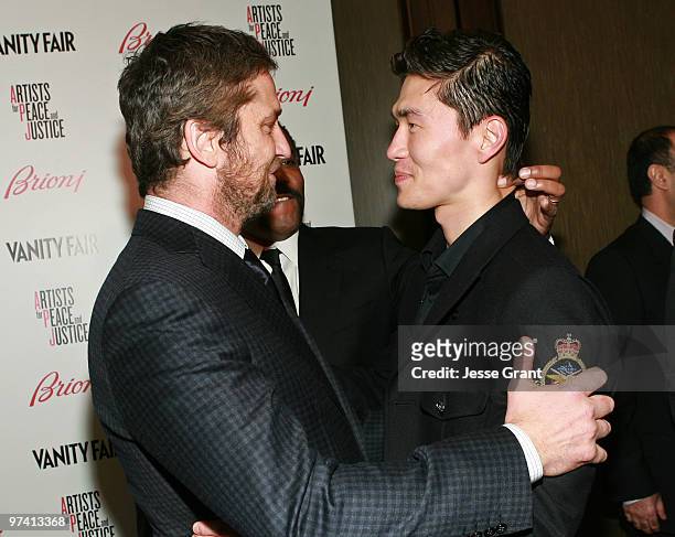 Actors Gerard Butler and Rick Yune attend Artists for Peace and Justice hosted by Vanity Fair and Brioni held at Bar Nineteen 12 on March 3, 2010 in...