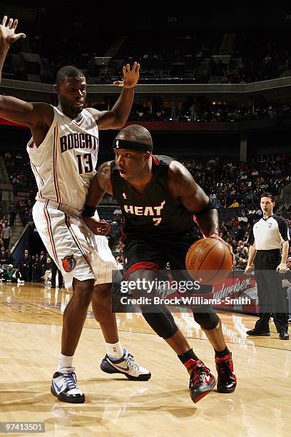 Jermaine O'Neal of the Miami Heat drives to the basket against Nazr Mohammed of the Charlotte Bobcats during the game at Time Warner Cable Arena on...