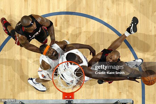 Rafer Alston of the Miami Heat shoots a layup against DeSagana Diop and Gerald Wallace of the Charlotte Bobcats during the game at Time Warner Cable...