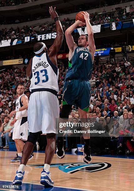 Kevin Love of the Minnesota Timberwolves shoots a jumper against Brendan Haywood of the Dallas Mavericks during a game at the American Airlines...