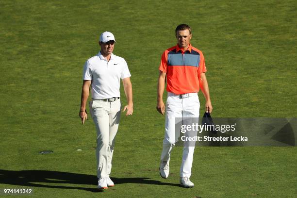 Rory McIlroy of Northern Ireland and Jordan Spieth of the United States walk the tenth hole during the first round of the 2018 U.S. Open at...