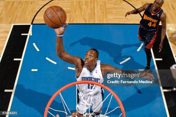 Dwight Howard of the Orlando Magic reaches for a rebound against the Golden State Warriors during the game on March 3, 2010 at Amway Arena in...