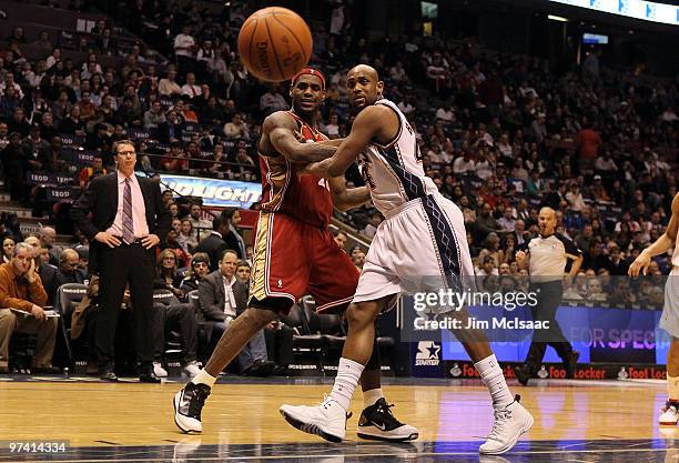 LeBron James of the Cleveland Cavaliers keeps his eye on the ball as he is defended by Trenton Hassell of the New Jersey Nets at the Izod Center on...