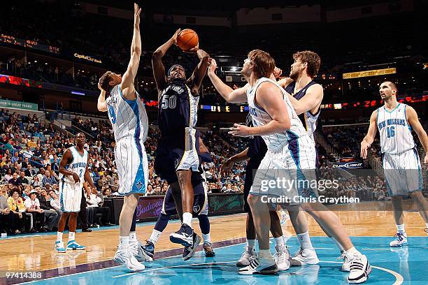 Zach Randolph of the Memphis Grizzlies shoots the ball over Darius Songaila and Aaron Gray of the New Orleans Hornets at the New Orleans Arena on...