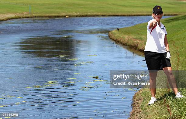 Karrie Webb of Australia looks for her ball after hitting in into the water on the 8th hole during round one of the 2010 ANZ Ladies Masters at Royal...