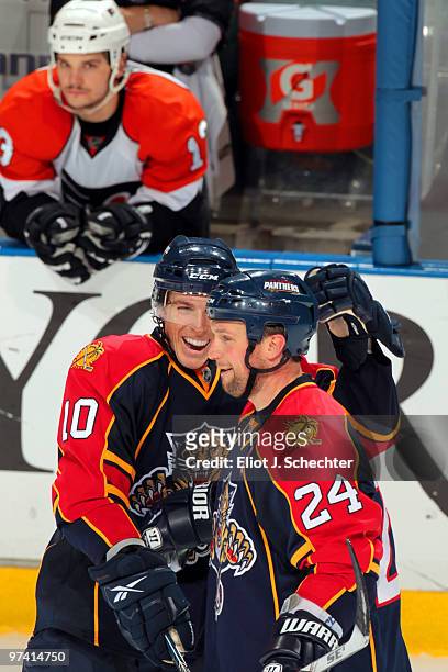 Bryan McCabe of the Florida Panthers and teammate David Booth celebrate their 7-4 win against the Philadelphia Flyers at the BankAtlantic Center on...
