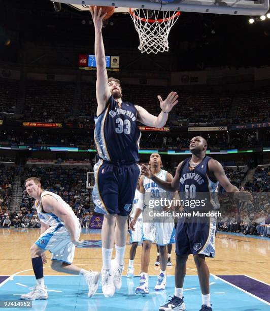 Marc Gasol of the Memphis Grizzlies shoots over Darius Songaila and David West of the New Orleans Hornets as well as Zach Randolph of the Memphis...