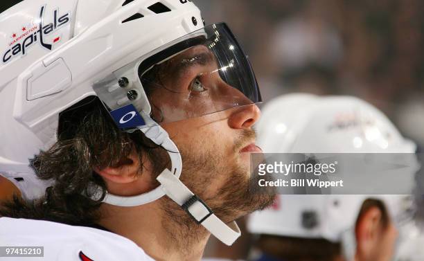 Alex Ovechkin of the Washington Capitals pays close attention to a scoreboard replay while on the bench during their game against the Buffalo Sabres...
