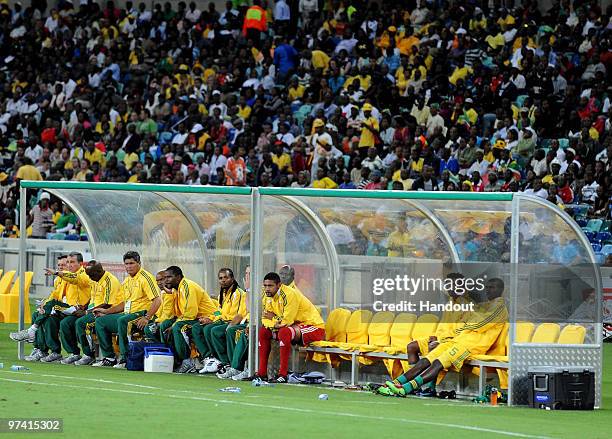 In this handout photo provided by the 2010 FIFA World Cup Organising Committee South African players sit on the bench during the International...