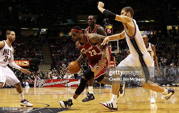 LeBron James of the Cleveland Cavaliers controls the ball against the New Jersey Nets at the Izod Center on March 3, 2010 in East Rutherford, New...
