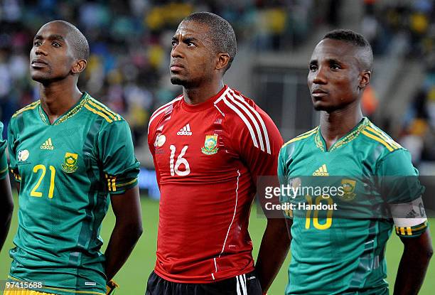 In this handout photo provided by the 2010 FIFA World Cup Organising Committee Anele Ngcongca, Itumeleng Khune and Teko Modise of South Africa line...