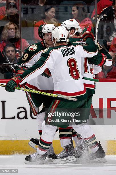 Brent Burns, Mikko Koivu and teammates of the Minnesota Wild celebrate a goal against the Calgary Flames on March 3, 2010 at Pengrowth Saddledome in...