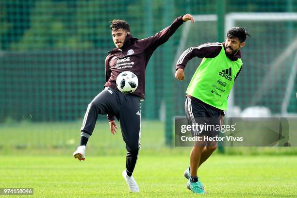 Diego Antonio Reyes and Oribe Peralta of Mexico struggle for the ball during a training session at FC Strogino Stadium on June 12, 2018 in Moscow,...