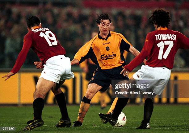 Robbie Fowler of Liverpool takes on Tommasi and Samuel of Roma during the match between AS Roma and Liverpool in the UEFA Cup fourth round, first leg...