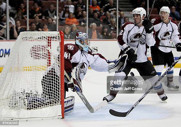 Goaltender Craig Anderson of the Colorado Avalanche makes a save in front of teammate Scott Hannan against the Anaheim Ducks in the third period at...