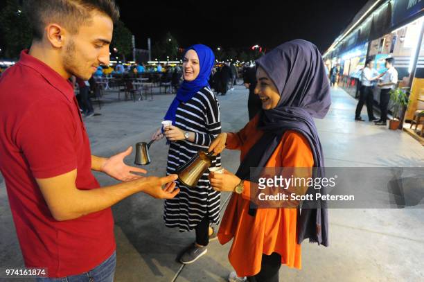June 10: Coffee is handed out by young women supporters of Turkey's ruling Justice and Development Party , as Turkish taxi drivers gathered with...
