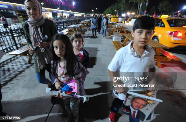 June 10: A family leaves after an event where Turkish taxi drivers gathered with their cars in protest at the presence of Uber in Turkey, at a...