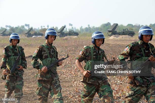 Cambodian soldiers walk during a military exercise to test fire multiple rocket launchers at the air field in Kampong Chhnang province, some 120...