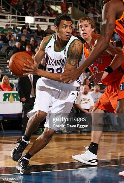 Romel Beck of the Dakota Wizards drives baseline past a pair of Albuquerque Thunderbirds defenders including Chad Toppert in the second half of their...