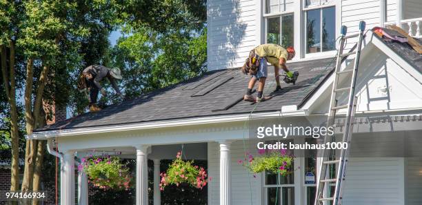 sustitución de contratistas de techos dañan cubiertas después de una tormenta de granizo - tejado fotografías e imágenes de stock