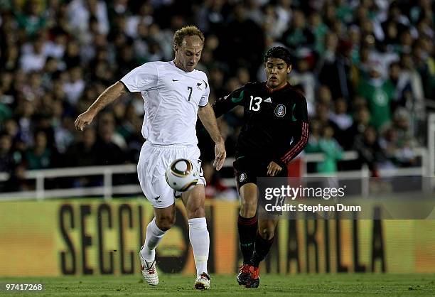 Simon Elliott of New Zealand battles for the ball with Jonathan Dos Santos of Mexico in an international friendly at the Rose Bowl on March 3, 2010...