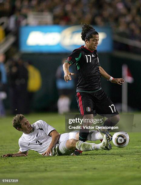 Tony Lochead of New Zealand slides in for the tackle on Giovani Dos Santos of Mexico in the second half during their International Friendly match at...