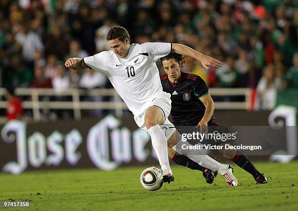 Chris Killen of New Zealand plays the ball through midfield under pressure from Andres Guardado of Mexico in the second half during their...